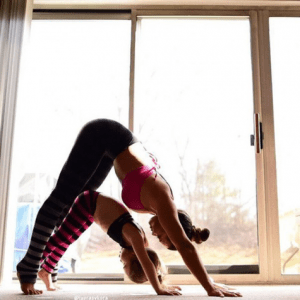 Mom and young daughter doing yoga