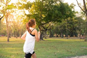 Woman running in woods