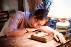 Girl sleeping while sitting at desk